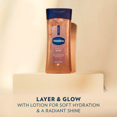A bottle of Vaseline Sunlit Glow gel oil stands on a light pedestal beside text