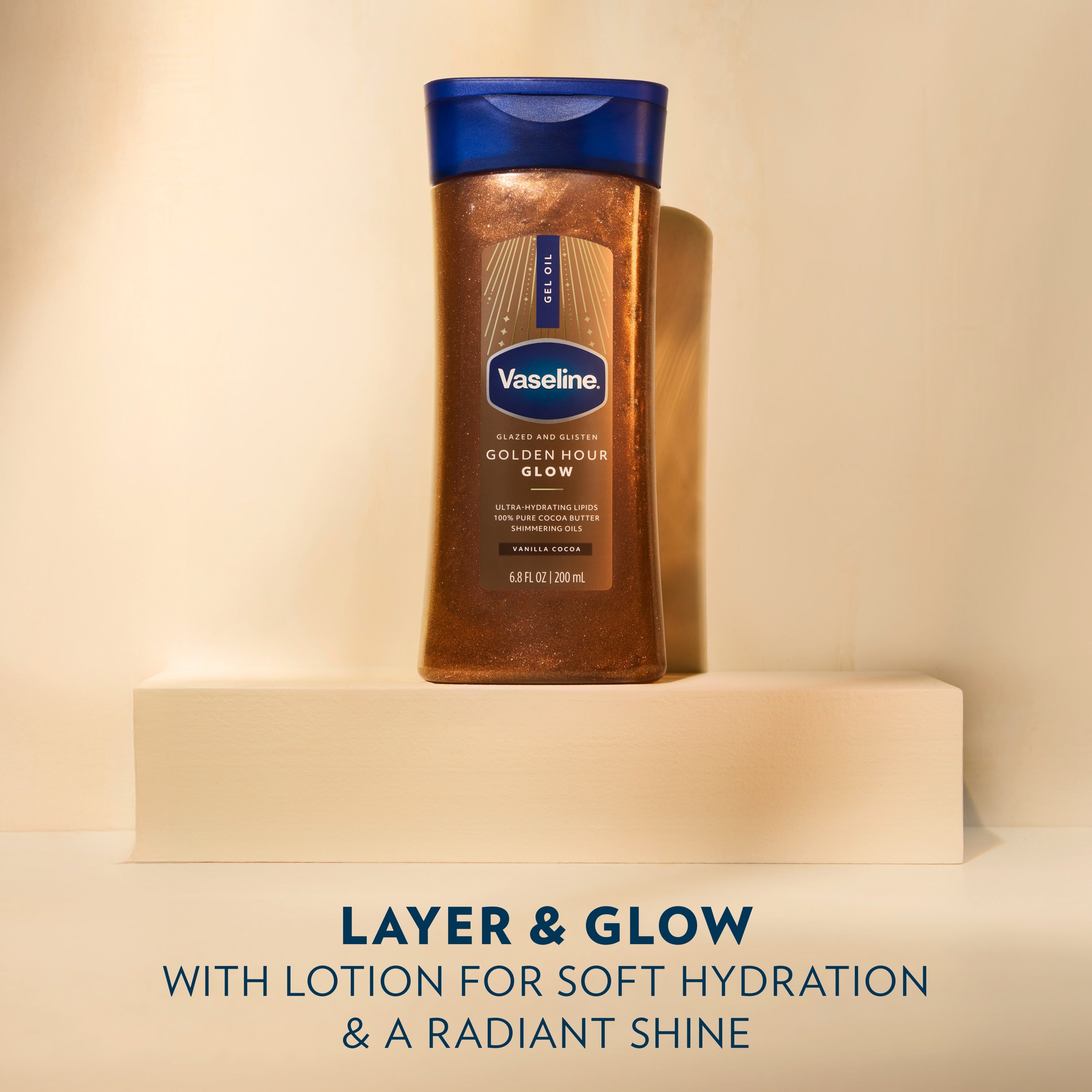 A bottle of Vaseline Golden Hour Glow Gel Oil is displayed on a pedestal with text