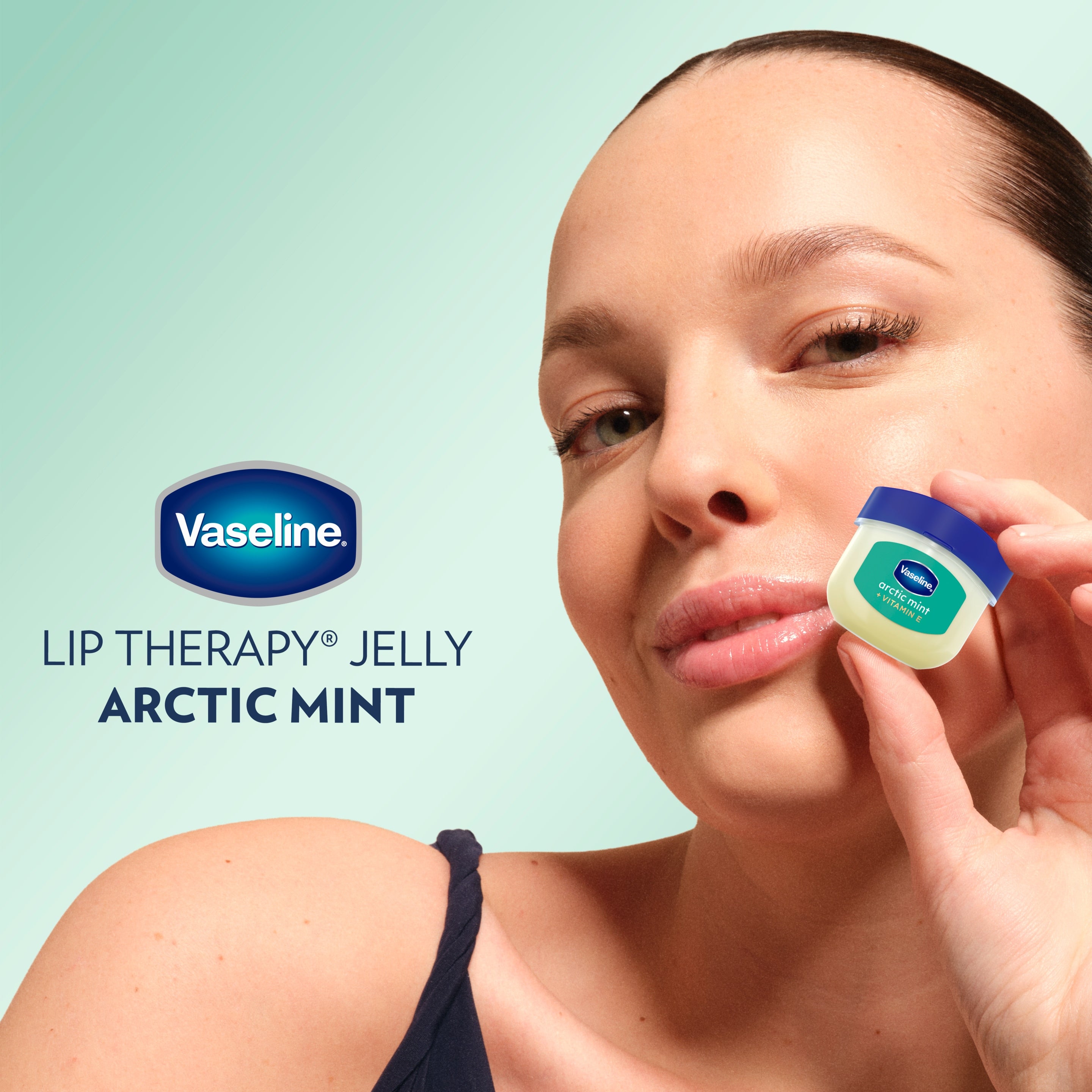 A model holds up a Vaseline® Lip Therapy® Arctic Mint Mini in front of her face
