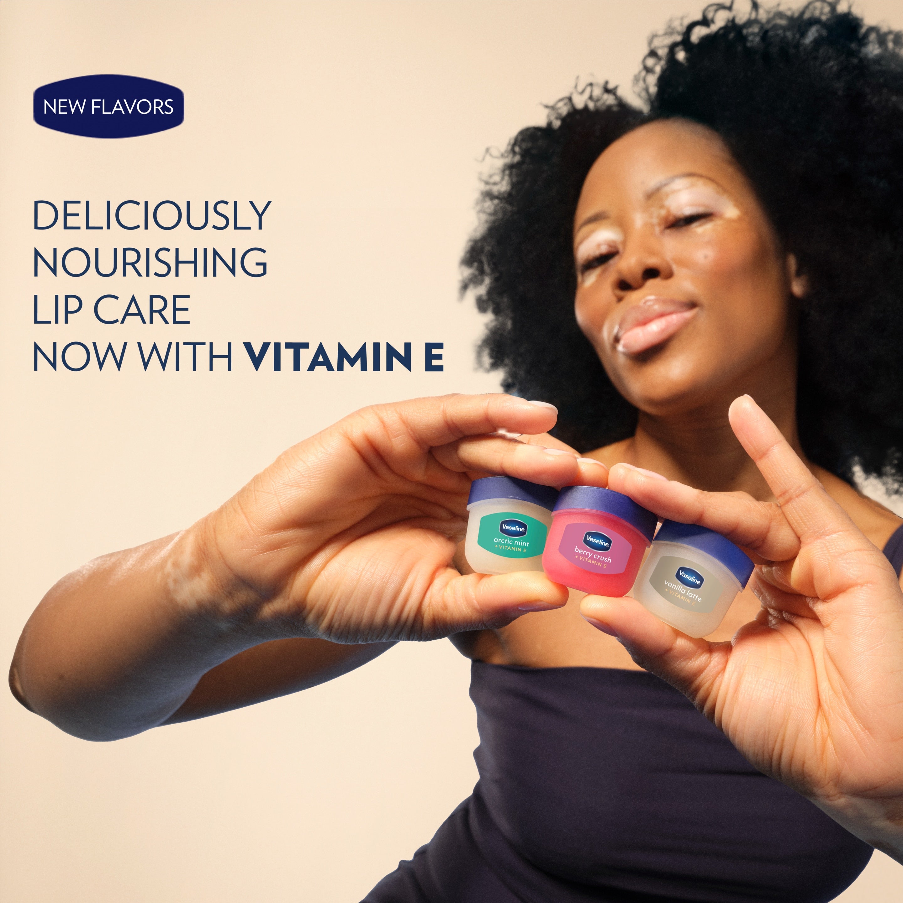 A model holds three small Vaseline Lip Therapy minis in different colors beneath text