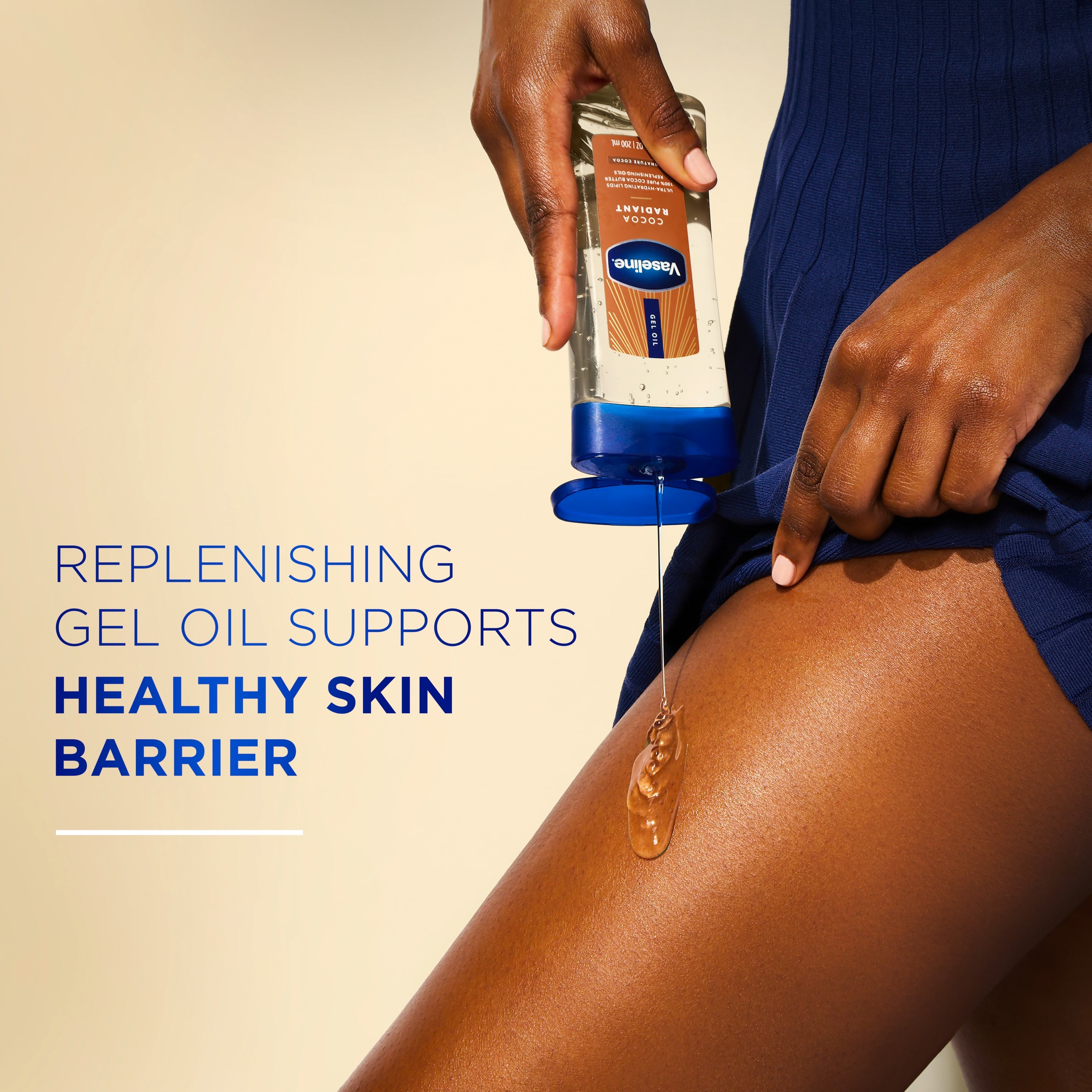 A person pours Vaseline Cocoa Radiant gel oil onto the thigh